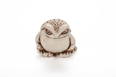 Netsuke toad on white の写真素材