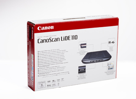 Cardboard box of CanoScan Lide 110. Ultra compact 2400dpi Scanner with \Auto Scan\ button. Imported...