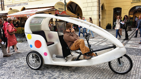 Velotrixi driver is waiting for passengers and talking on cell phone in Old Town Pragueのeditorial素材