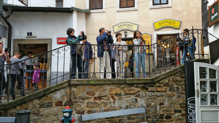 Krumlov, Czech Republic - October 1, 2014: Asian tourists stand on the old stone staircase and shooting medieval buildings of Cesky Krumlovのeditorial素材