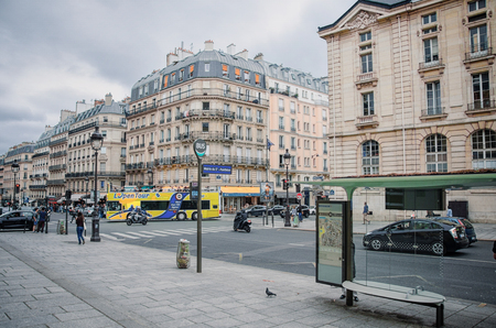 Paris,  France - June 3, 2017: Empty bus stop Mairie du 5e-Pantheon located at Rue Soufflot. Sightseeing tour bus moves the middle. There are attractive buildings with attic roofs in the backgroundのeditorial素材