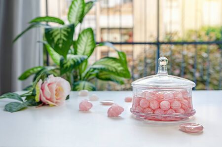 Rose quartz small balls charge spring water with their energy in a glass jar. The water absorbs...