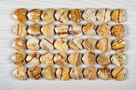 Forty picture jasper heart-shaped stones are stowed five rows. Eight pieces in each one. Top view.の写真素材
