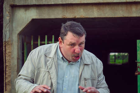A madman with a twisted face emerges from a dark abandoned tunnel.の写真素材