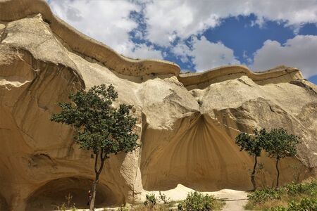 Turkey Cappadocia Amazing cliffs like mushrooms are flooded with sunlight, clouds are in the sky.の写真素材