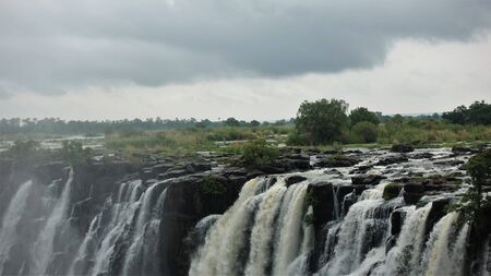 Victoria Falls in Zambia. Powerful streams of water collapse into the abyss. Low clouds. Fog.の写真素材