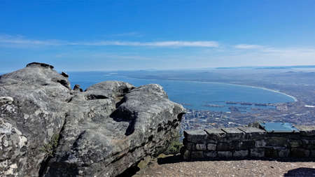 Magnificent panorama from the top of Table Mountain. An ancient gray boulder lies on the observation...