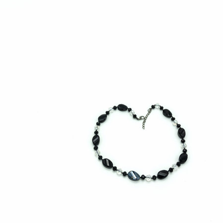 Women's necklace made of black and transparent faceted beads of different sizes. Metal clasp. Isolated on white background.の写真素材