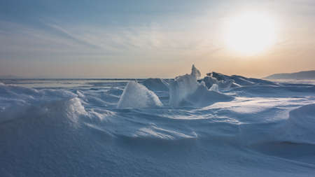 Ice floes rise from the snowdrifts. Whimsical outlines against the background of the evening sky....