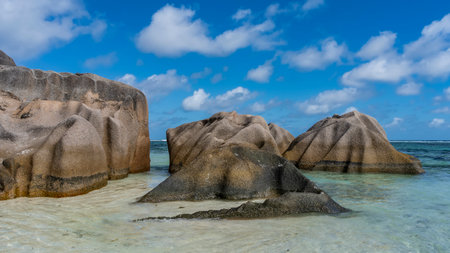 Picturesque huge granite boulders in the turquoise ocean. Bizarre outlines. Smoothed folded slopes....