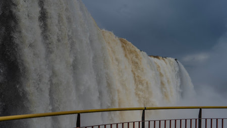 Powerful streams of the waterfall. Close-up. White foaming water collapses from the edge of the...