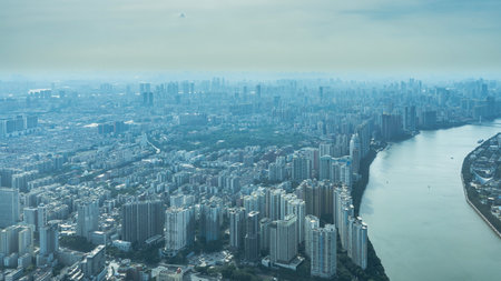 Panorama of the city from the observation deck of the Canton Tower. The riverbed bends. Lots of skyscrapers, multi-storey buildings to the horizon. Clouds in the sky. China.の写真素材