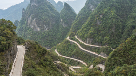 The famous 99 turns mountain road. The roadway twists and meandering along steep slopes covered with...