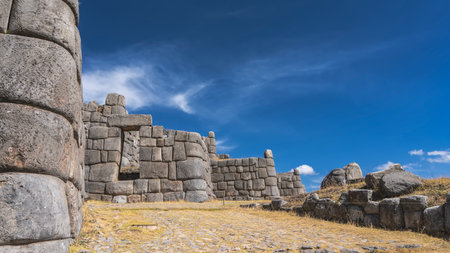 Ruins of an ancient Inca fortress Sacsayhuaman. Zigzag shaped protective battlement wall, polygonal...