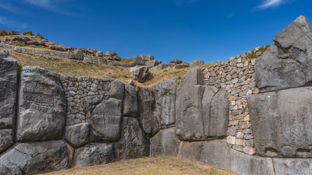 Ruins of an ancient Inca fortress Sacsayhuaman. Polygonal ashlar masonry walls. The huge boulders are smoothly hewn and closely fitted. The blue sky. Peru. Cusco.の写真素材