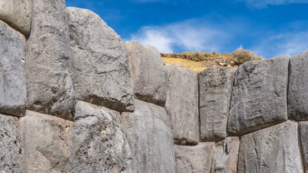Ruins of the ancient Inca fortress Sacsayhuaman. A fragment of the wall. Close-up. The boulders are smoothly hewn and closely fitted. Strange indentations on the surfaceの写真素材