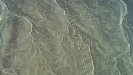 The Nazca Desert. Aerial view. An ancient geoglyph is visible on a sandy plateau - a giant drawing...
