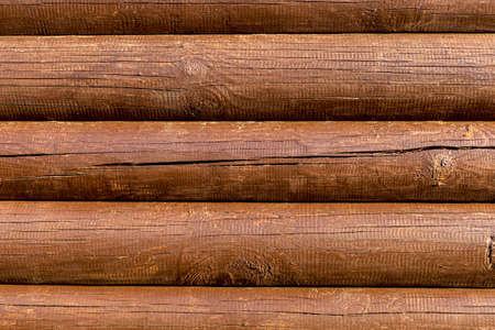 Wooden log brown background horizontal lines of painted wood with cracks and tar bleedの写真素材