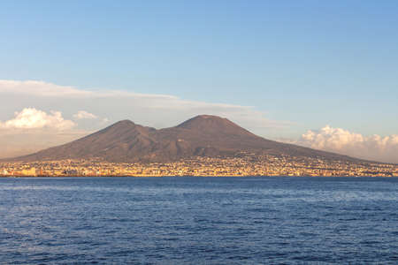 Landscape overlooking Mount Vesuvius in Naples with blue sea coastline, white clouds, blue sky and...