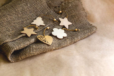 Background from festive natural, different wooden toys in the form of a Christmas tree, a heart, a...