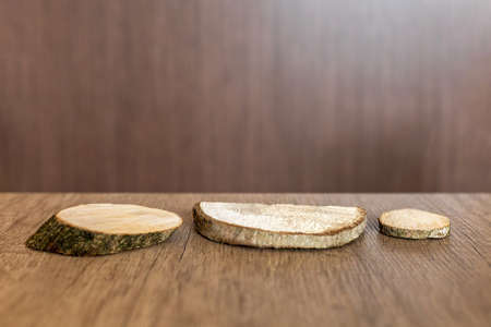 Wooden cuts, natural wood podium on a textured table. Idea for advertisingの写真素材