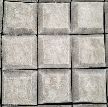 Gray square concrete buttons with cracks and irregularities, stone keyboardの写真素材