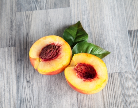 Fresh nectarines on wooden table の写真素材
