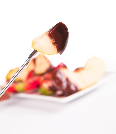 apple dipped in chocolate fondue の写真素材