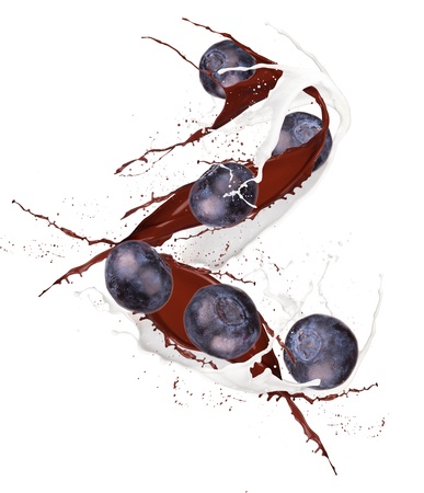 Fresh bilberry in chocolate and mill splash over white background の写真素材