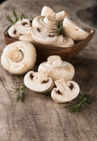 Fresh champignon mushrooms on wood の写真素材