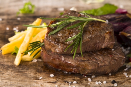 Grilled steaks on wood の写真素材
