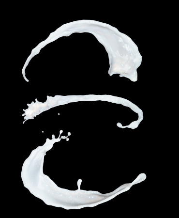 Milk splashes collection, isolated on black backgroundの写真素材