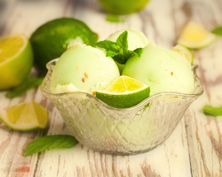 Ice cream lime on wodeen table with fruits の写真素材
