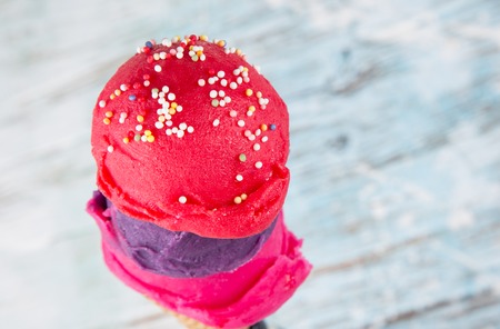 Ice cream cones in a metal basket on wooden table
