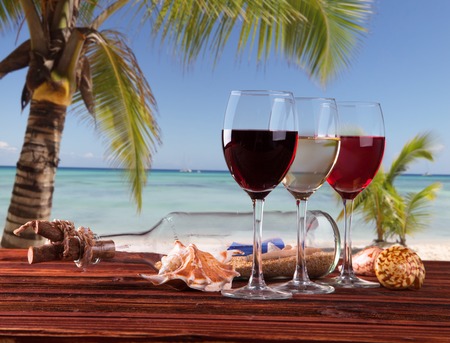 Summer concept, white nad red wine on tropical beach Blue sky, sea の写真素材
