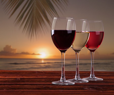 Wine and cheese on wooden table with fresh grapesの写真素材