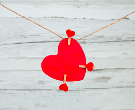 Valentine concept, red heart hang on wooden background