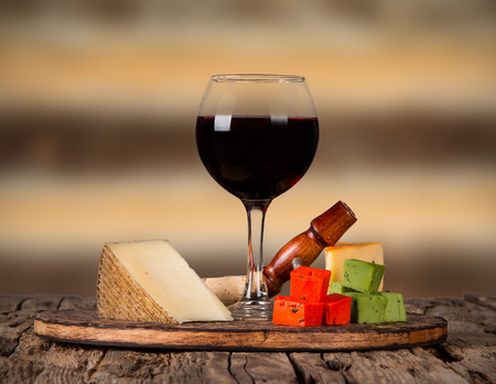 Wine and cheese on wooden tableの写真素材