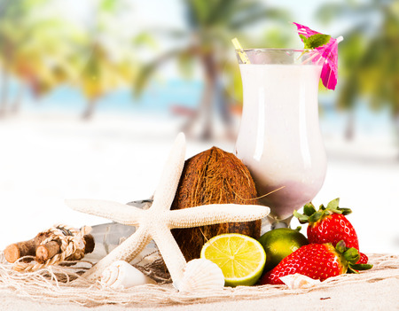 Summer drinks on sandy beach with blur beach の写真素材