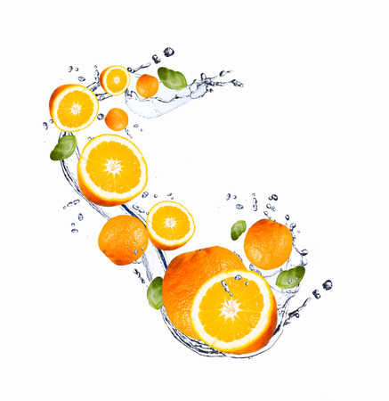 Fresh fruit in water splash, falling orangeの写真素材