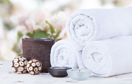 Spa concept still life with aromatic candles and flowerの写真素材