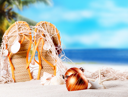 Christmas ornament on a beach, concept of a warm, tropical weather Christmasの写真素材