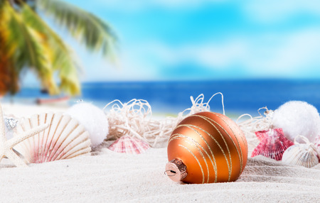 Christmas ornament on a beach, concept of a warm, tropical weather Christmasの写真素材