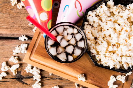 Popcorn and cola drink on wooden backgroundの写真素材