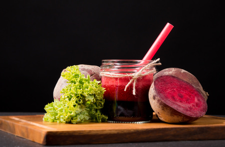 Fresh beetroot smoothie in glass on the black stone. Lifestyle conceptの写真素材