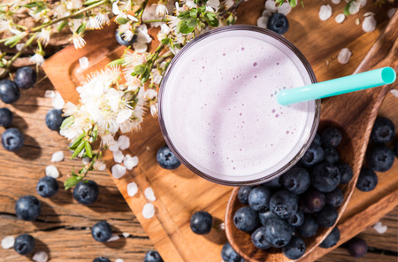Fresh milk, blueberry drink on wooden table, assorted protein cocktail with fresh fruits.の写真素材