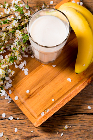 Fresh milk, banana drink on wooden table, assorted protein cocktail with fresh fruits.の写真素材