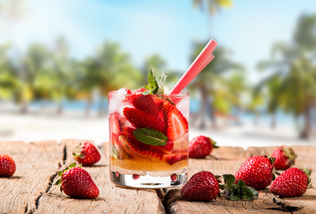 Strawberry drink on wood with blur beach backgroundの写真素材