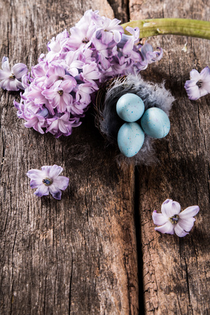Easter eggs and flower on wooden table. Spring concept on plank.の写真素材