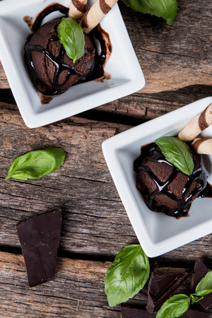 Ice cream, Chocolate ice cream scoop in cone on wooden tableの写真素材